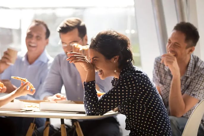 Employees laughing together in an office 