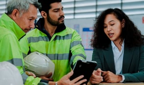 Team of employees reviewing health and safety information, demonstrating employee responsibilities for health and safety at work.