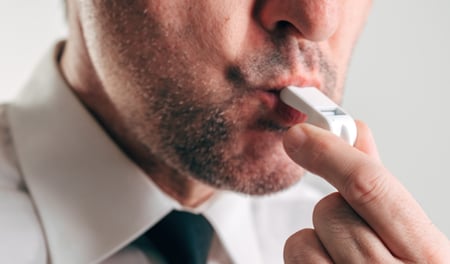 Man in a white shirt and tie blowing a whistle, representing whistleblowing in the workplace