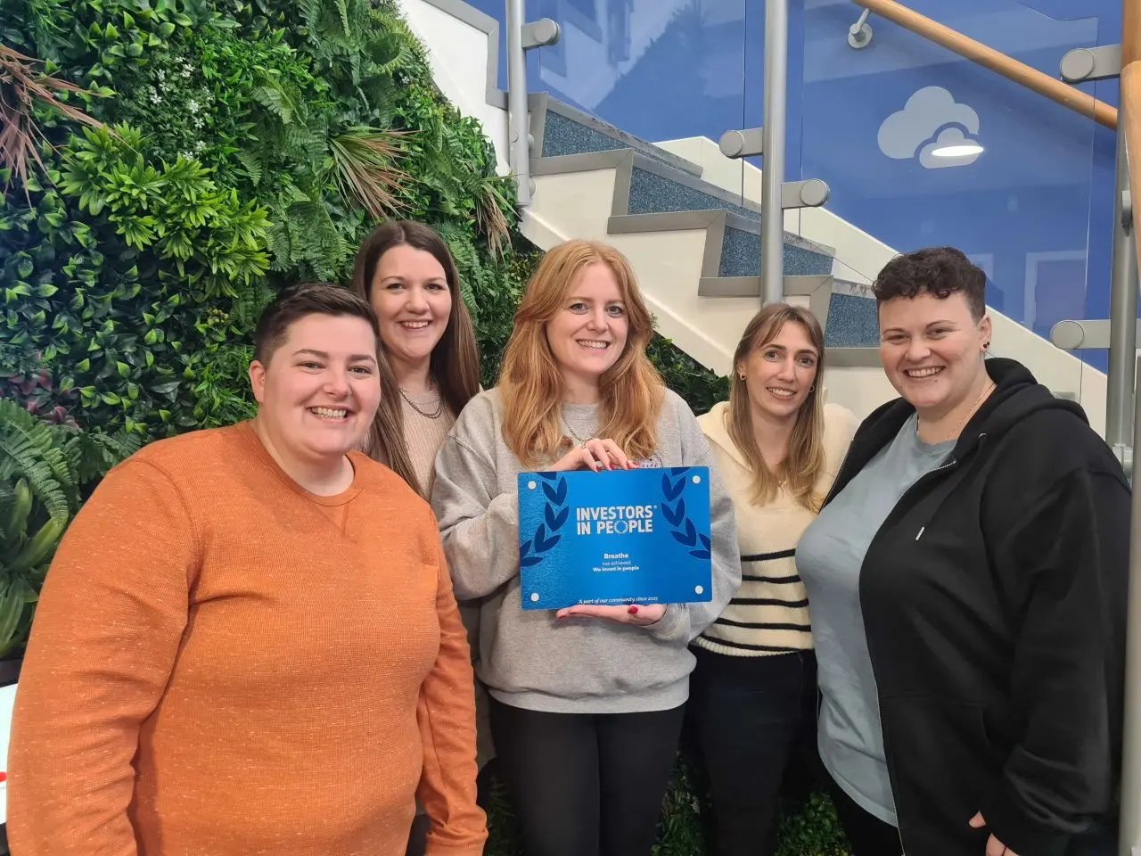 5 ladies holding the blue Breathe Investors In People award