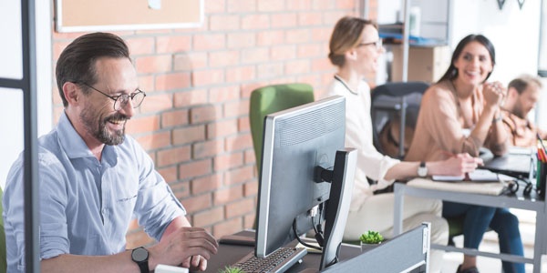 Happy employee working on laptop