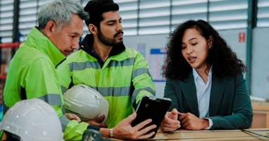 Team of employees reviewing health and safety information, demonstrating employee responsibilities for health and safety at work.