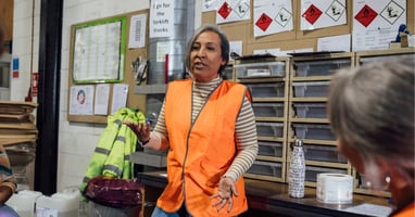 Supervisor speaking with employees about safe working practices, reflecting why health and safety is important at work.