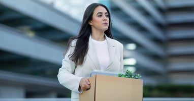 Worker carrying a box of belongings after their role ends, supporting our guide on what is redundancy.