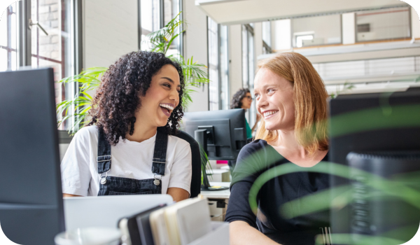 Two women in an office smiling