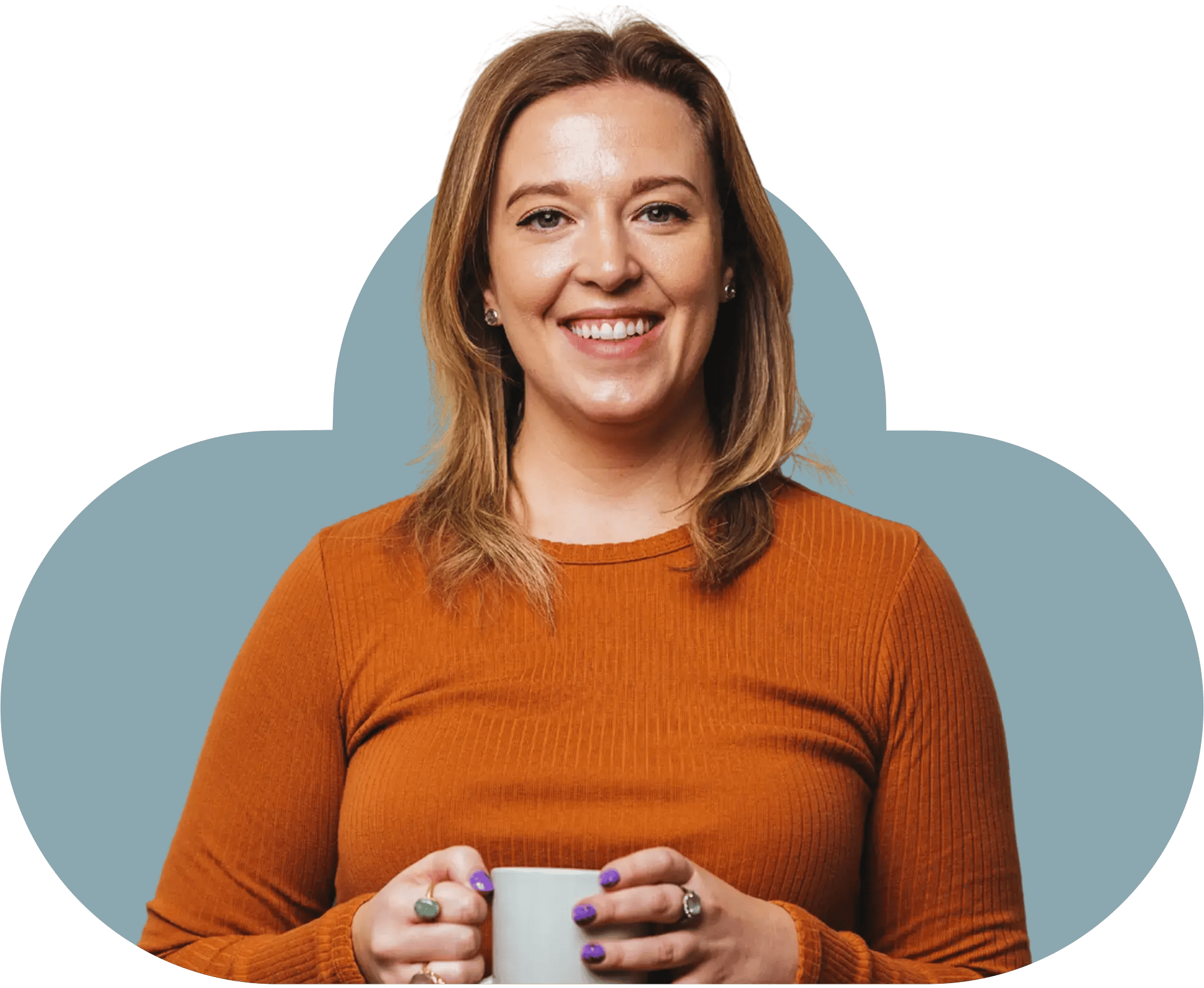 Speaker Lizzie Benton wearing an orange top holding a mug smiling towards the camera