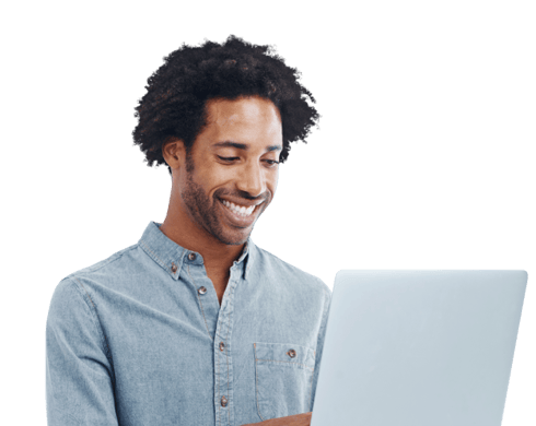 A man wearing a denim shirt smiling at the tablet he is holding