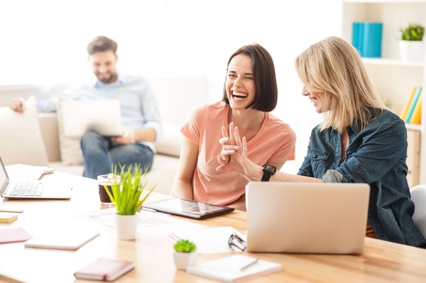 Happy employees laughing in the office