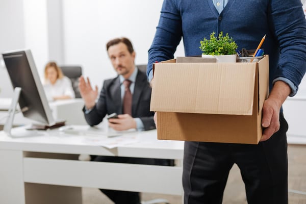 Employee leaving office with his box of belongings