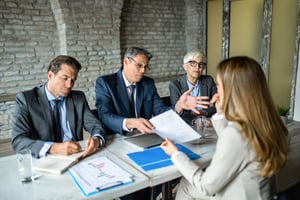A line manager and HR representatives conducting a formal disciplinary hearing with an employee, illustrating the importance of following a fair process to avoid an unfair dismissal claim.