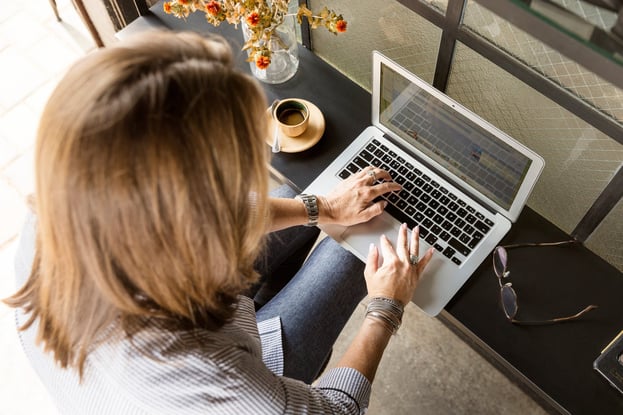 Lady sitting at a table on her laptop
