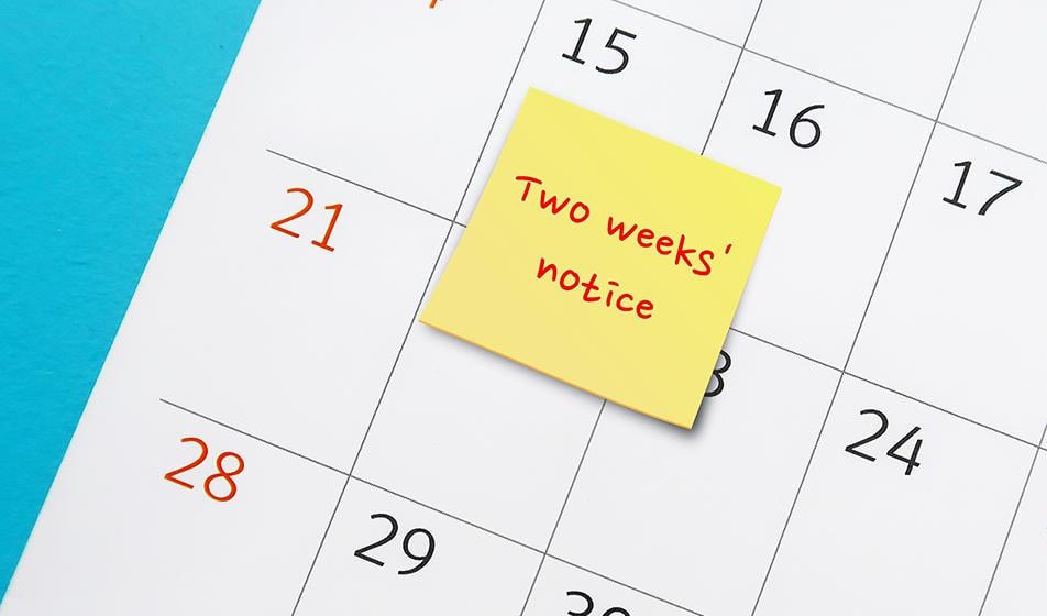 A calendar is shown, with a post-it note stuck on it, reading 'Two weeks' notice'