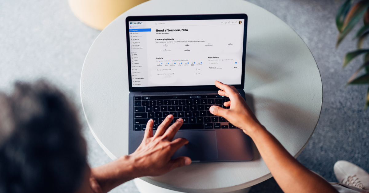 A laptop displaying Breathe HR, an all-in-one HR software that's built for SMEs with features like absence management, holiday tracking, performance management, training, health and safety and more. 