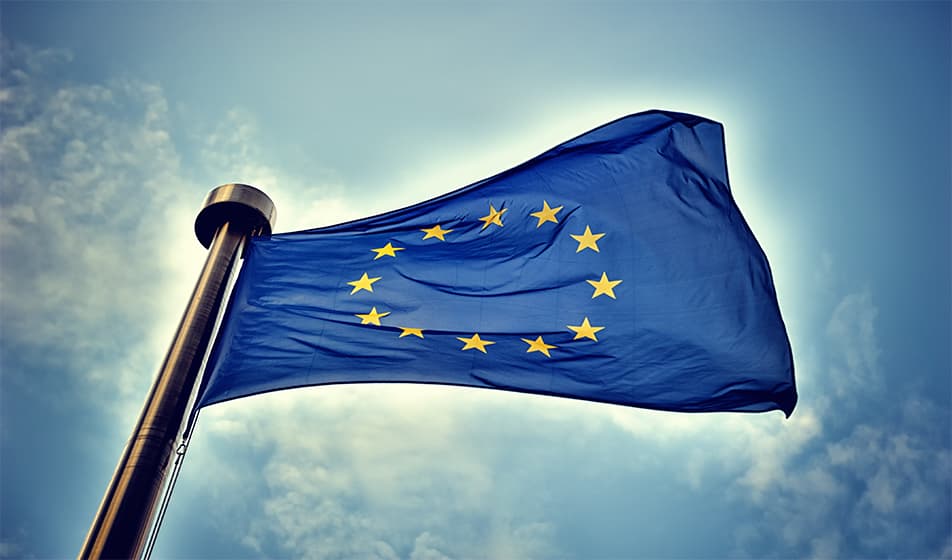 An image of the EU flag waving in the sky.