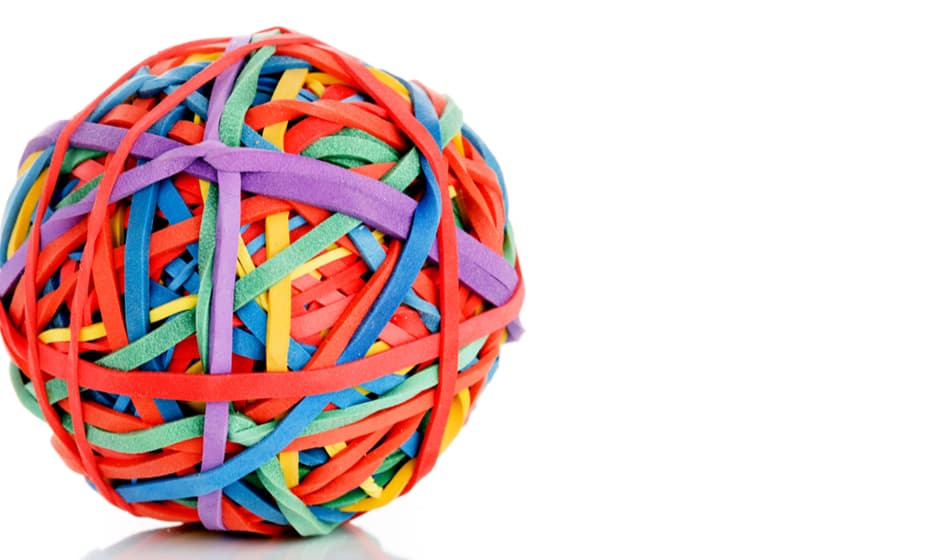 A ball made up of colourful elastic bands against a white background.