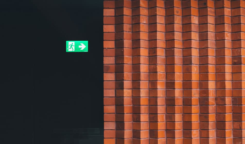 Fire exit sign next to a wall