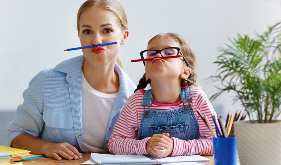 Mum and daughter playing with pencils