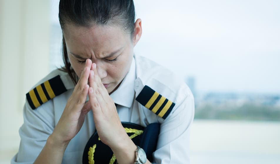 Pilot praying in an airport lounge