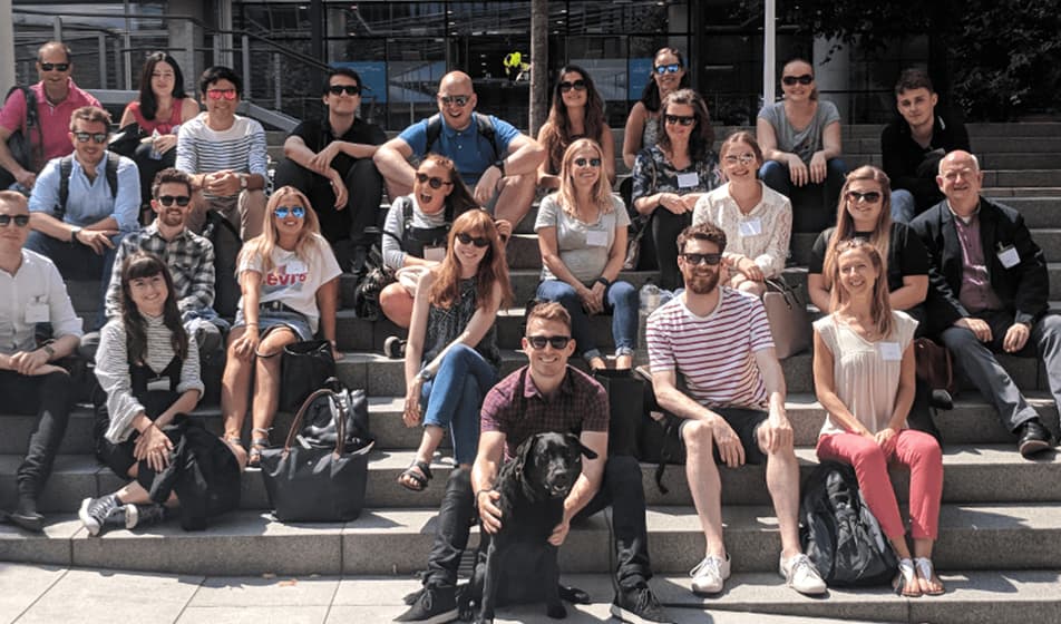 Picture of Topline Comms employees sitting outside their office