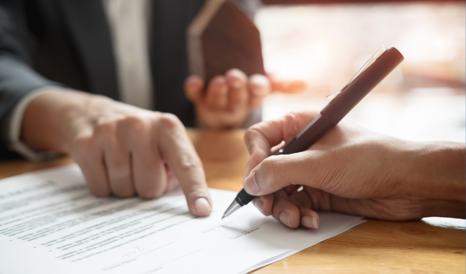 A close-up shot of a worker's hand pointing at employment law policies and contracts that need updating in line with the employment law changes coming into effect in 2026 and 2027, as a result of the Employment Rights Act 2025.  