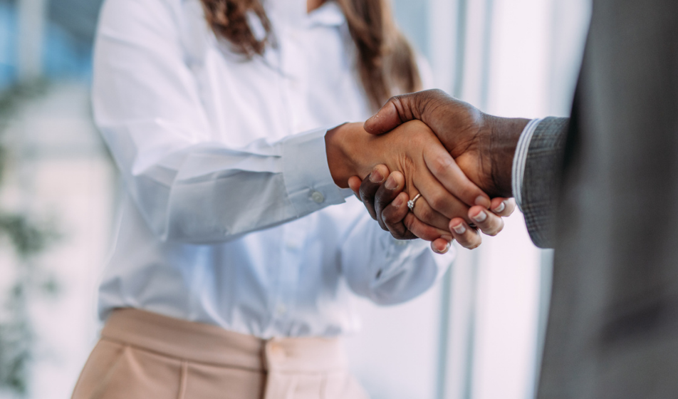 Employee shakes hands with their manager in positive acceptance of voluntary redundancy.