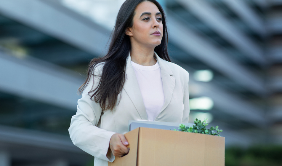 Worker carrying a box of belongings after their role ends, supporting our guide on what is redundancy.