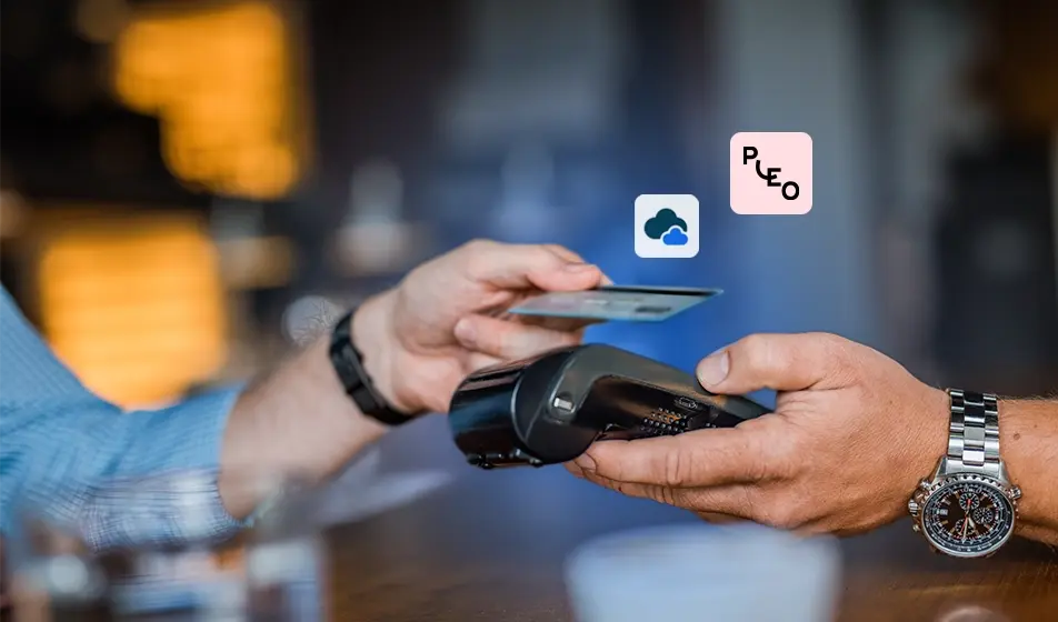 Two hands involved in a contactless payment, one holding a Pleo card, the other a payment device.