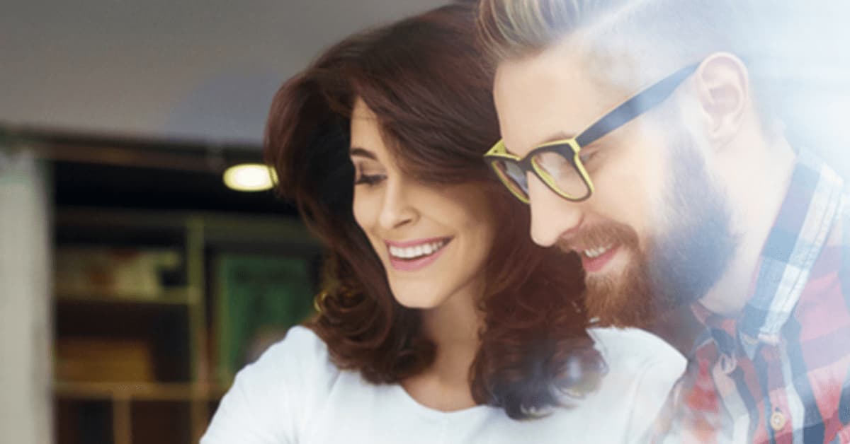 Happy lady and man looking at paperwork