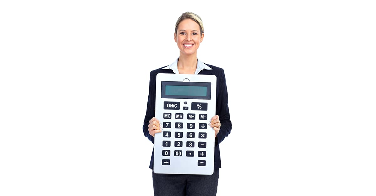 A woman in a business suit is holding a giant silver and black calculator.