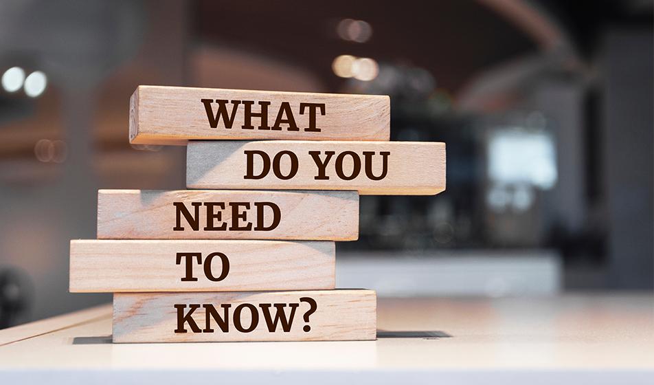 Wooden blocks are shown, stacked on top of each other. Each block has a word written on it, spelling out the sentence "what do you need to know?"