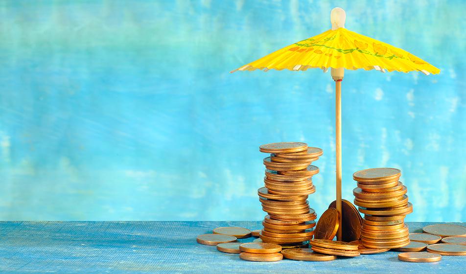 Piles of copper coins are shown stacked up against a cocktail umbrella masquerading as a parasol, against a blue background