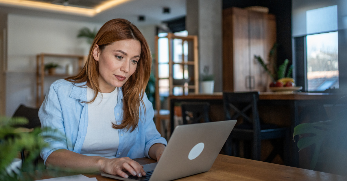 Employee working at a laptop in a home, illustrating work from home health and safety considerations