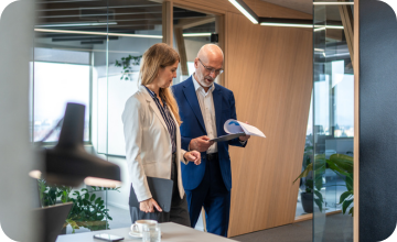 Two workers walking through an office, performing a risk assessment for their small business