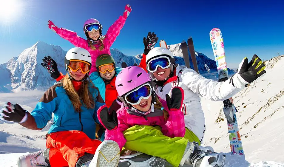 skiing happy family on the snowy slopes | Breathe