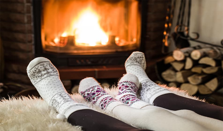 People relaxing in front of a fire