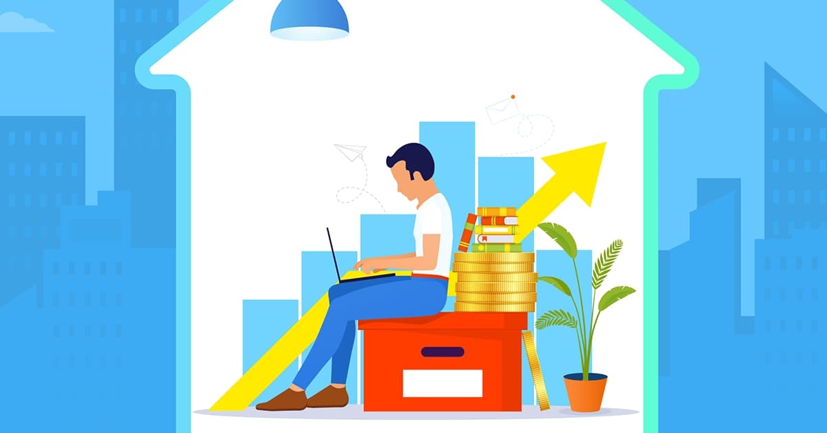 A cartoon of a man sat in a house. He is sat with his laptop on a red box, surrounded by a stack of coins, books and a plant. Behind him is a bar chart which shows growth.