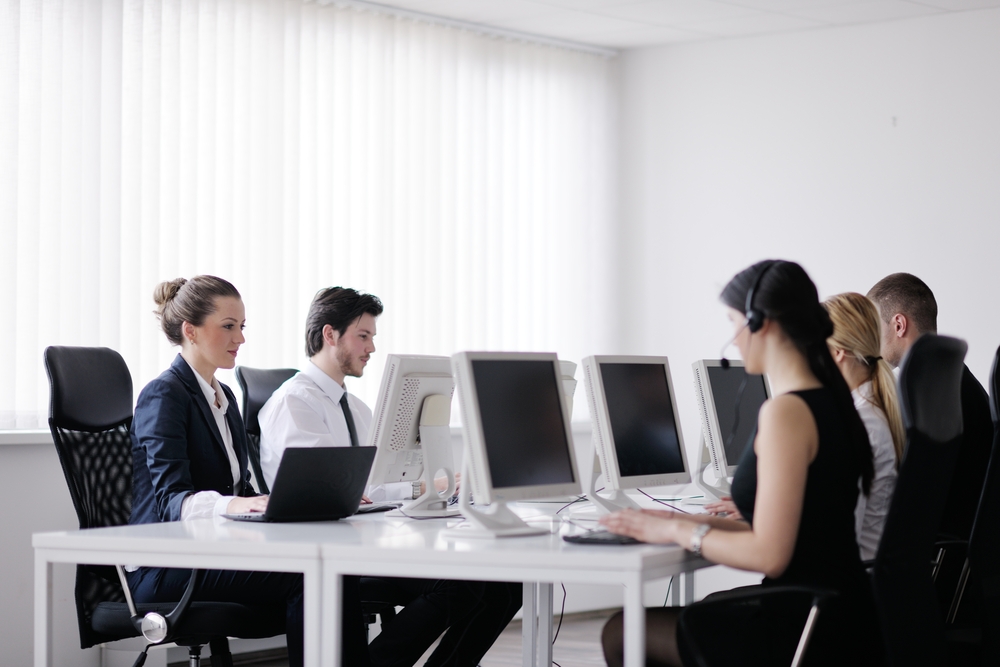 business people group with headphones giving support in help desk office to customers, manager giving training and education instructions