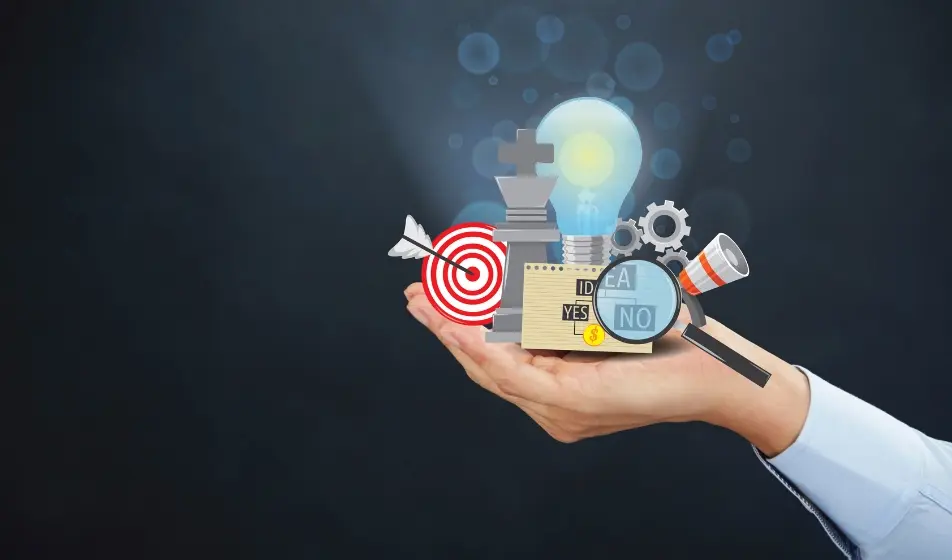 A close-up image of a hand holding various symbolic items related to strategy. The hand grasps a lightbulb, magnifying glass, target and arrow, cogs and puzzle pieces. These elements suggest the concept of strategy and thoughtful planning, all held together in the palm of one hand, conveying control and focus over multiple strategic tasks.