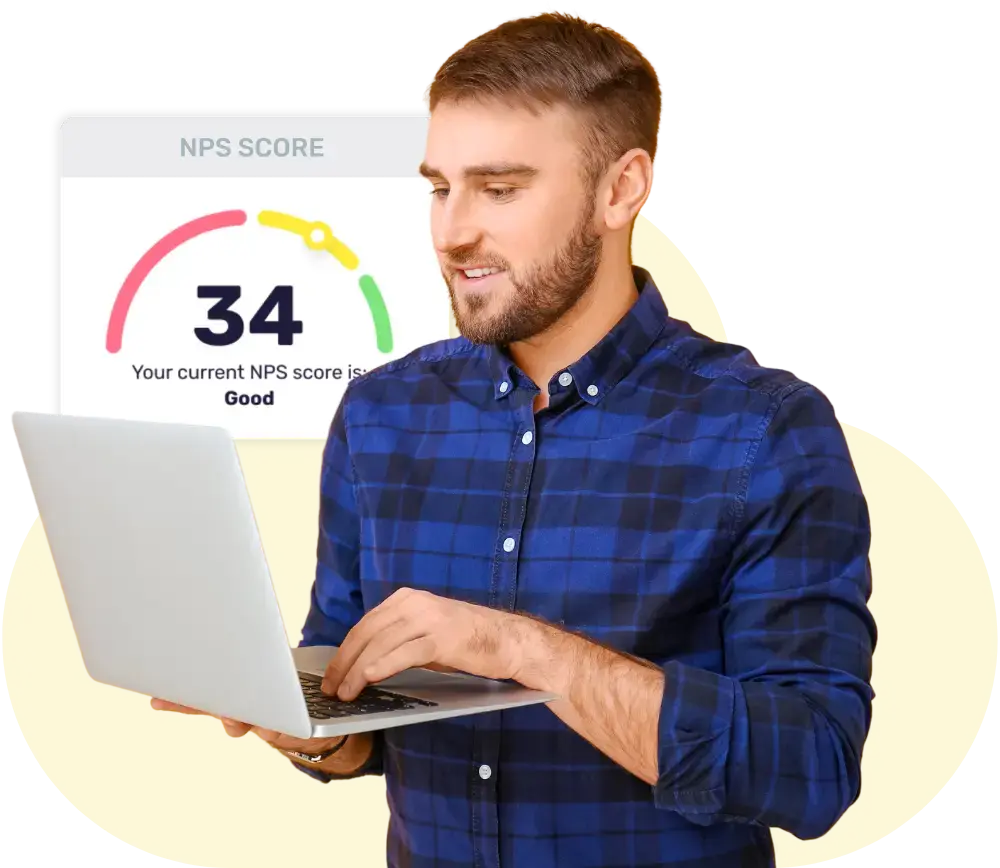 Man wearing blue checked shirt smiling at his laptop with a pop up behind him of Breathe's employee NPS feature showing his businesses NPS score