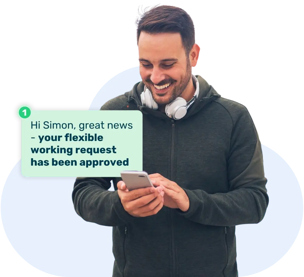 Man wearing headphones smiling at his phone with a pop up 'Hi Simon, great news - your flexible working request has been approved'