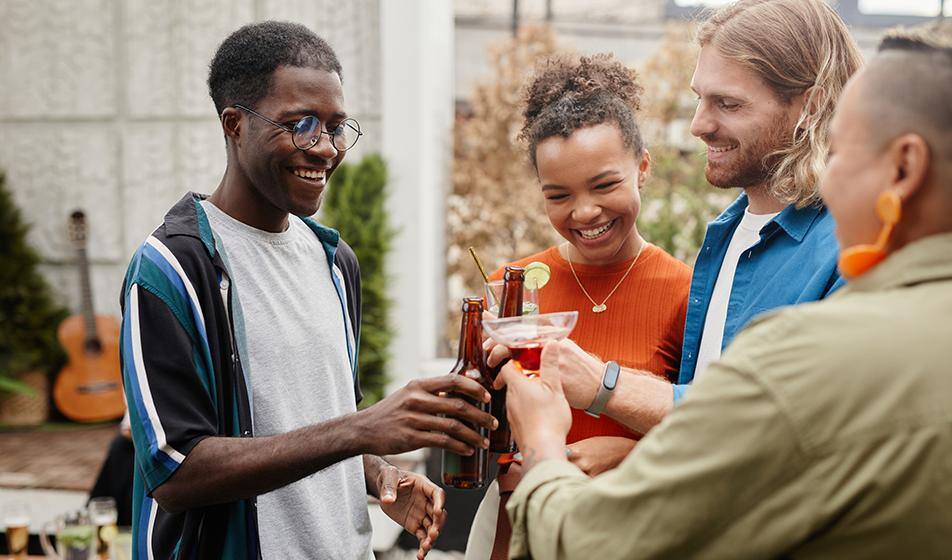 A group of employees are having drinks outside in what looks like an after-work social event