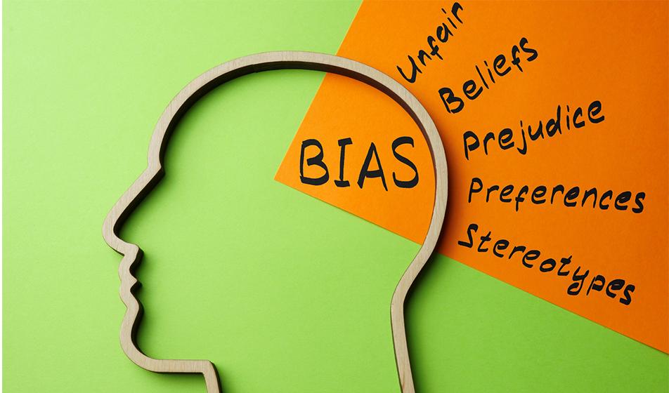 An abstract image shows the outline of a head against a lime green backdrop. The words 'bias', 'unfair', 'beliefs', 'prejudice', 'preferences' & 'stereotypes' are shown in and around the head.