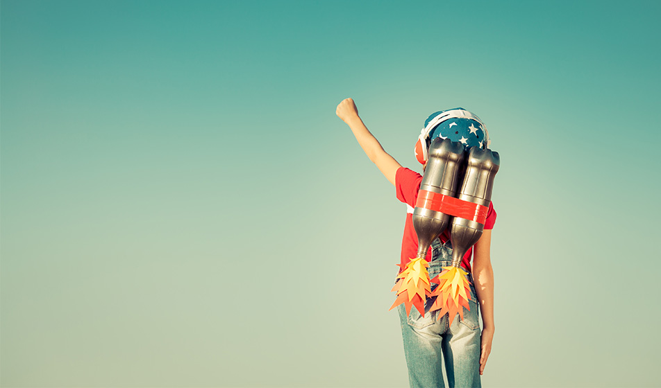 Person fist-pumping the air with a pretend launch pack on their back, with cartoon cut-out flames coming out 