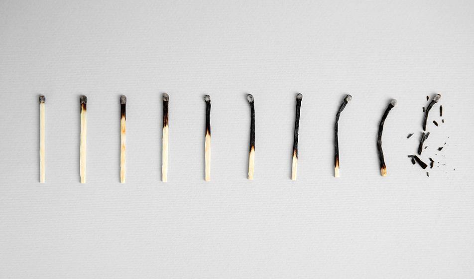 A row of matches is shown, each progressively further burned down that the rest, until the final one is completely black and broken apart, representing progressive burnout. 