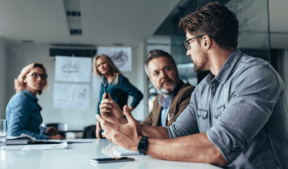 A group of people are in an office, talking 