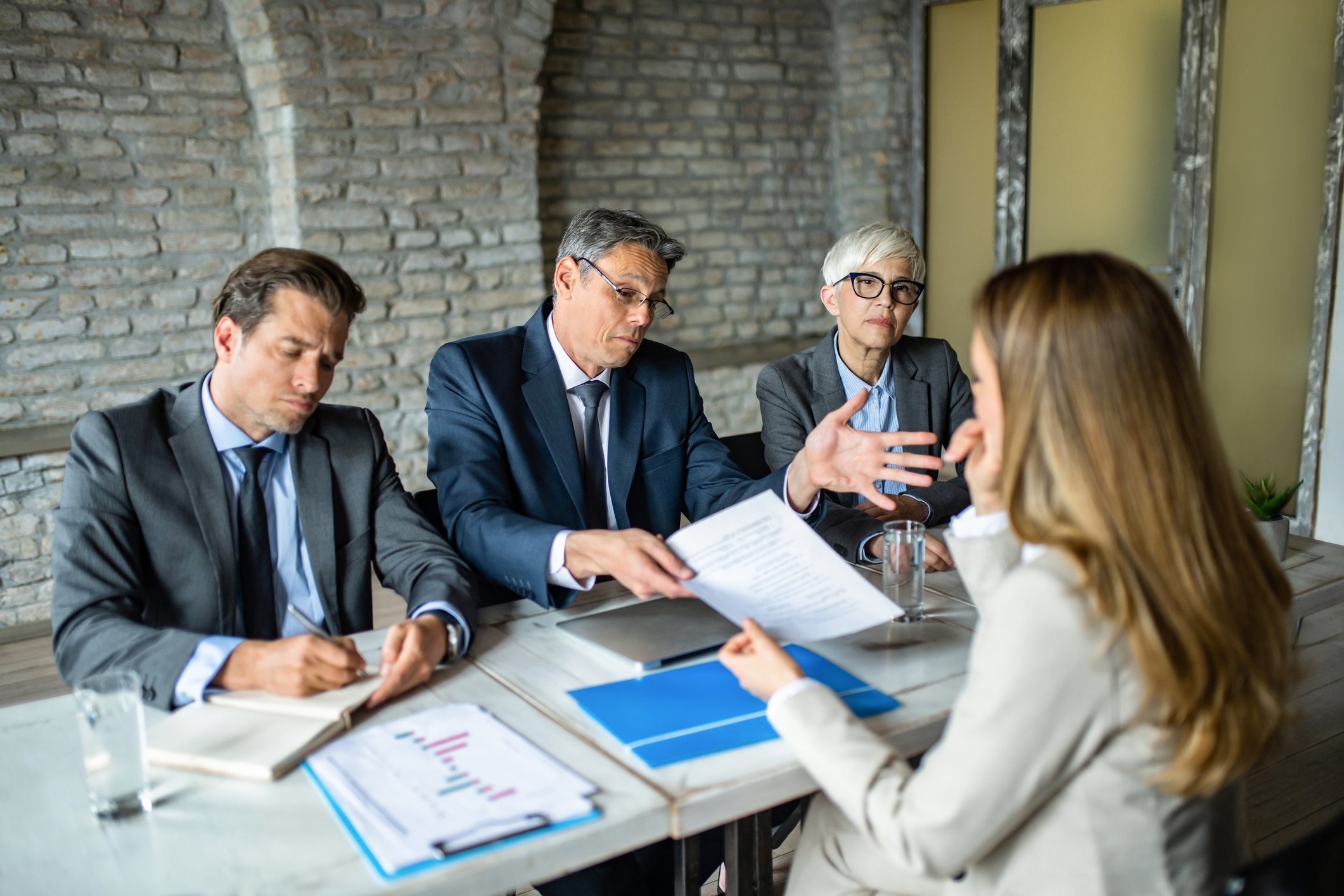 A line manager and HR representatives conducting a formal disciplinary hearing with an employee, illustrating the importance of following a fair process to avoid an unfair dismissal claim.