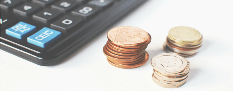 small businesses calculating expenses - photo of a calculator and some coins 