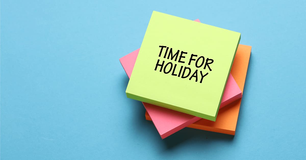'Time for holiday' wrote on a stack of sticky notes