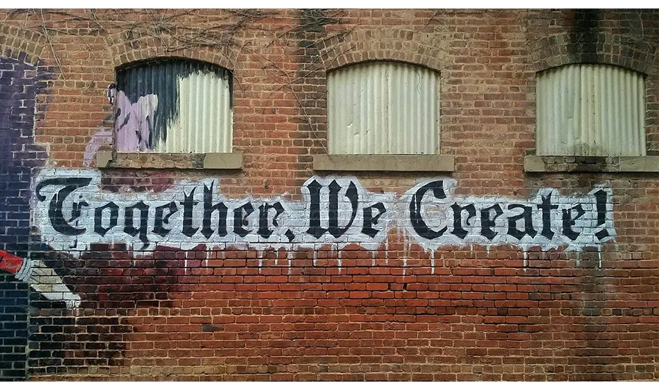 together we create on a brick wall