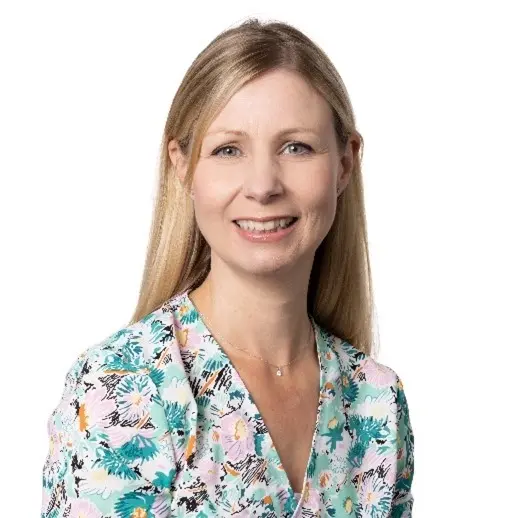 Photo of Helen, a lady with long blonde hair wearing a floral top